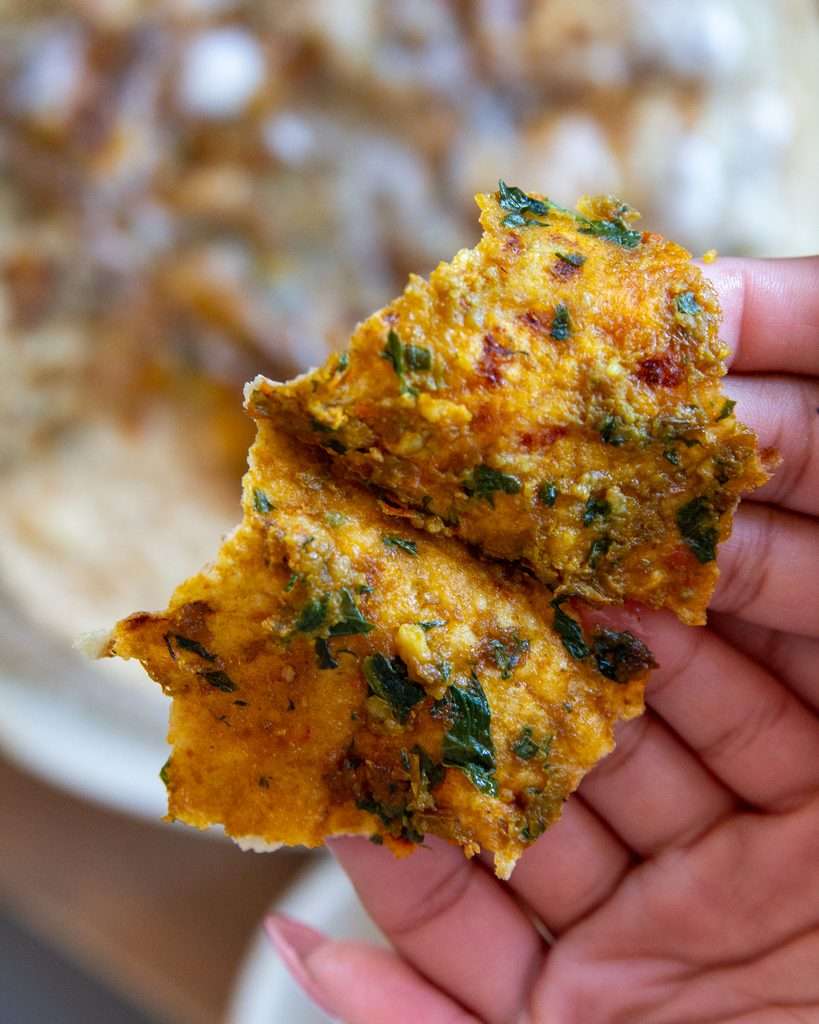 Paratha bite opened up showing texture of the filling