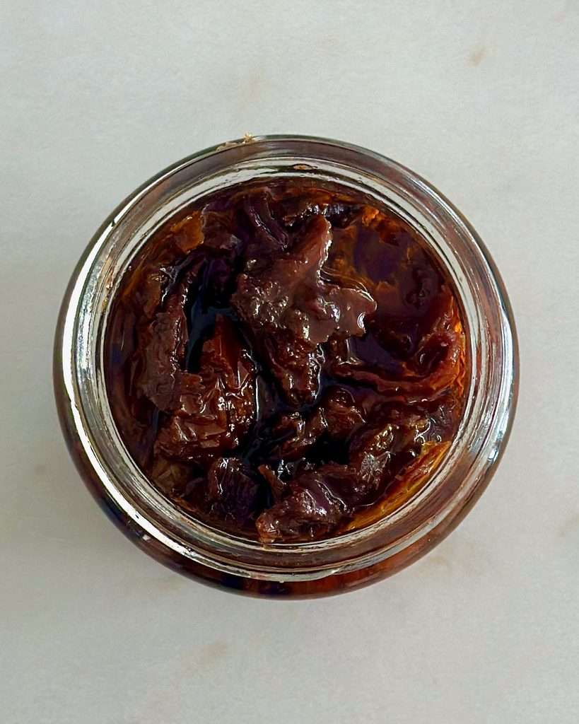 A jar of sun dried tomatoes in olive oil